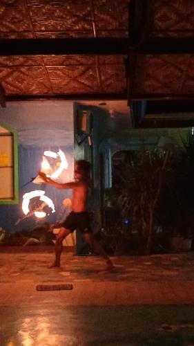 a young boy running down a street at night at Villa-Atlas Guest House in Malapascua Island