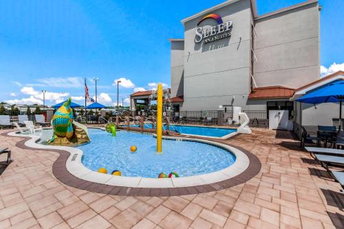 a pool at a resort with a playground at Sleep Inn & Suites Rehoboth Beach in Rehoboth Beach