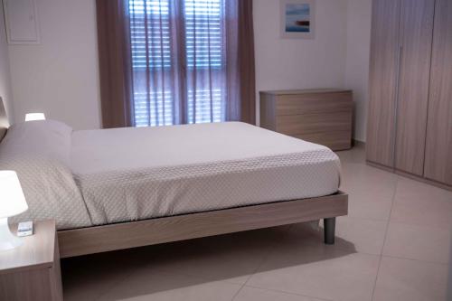 a bedroom with a bed and a large window at Central View Apartment in Cava deʼ Tirreni