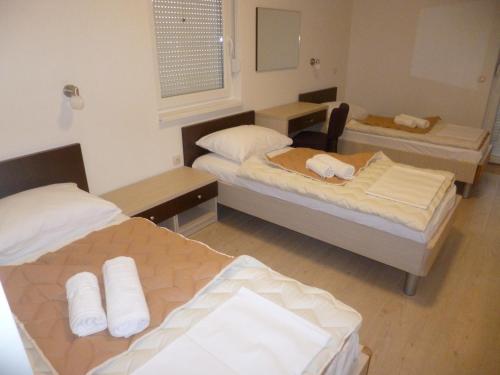 a room with two beds and a mirror at Hotel Stana in Međugorje