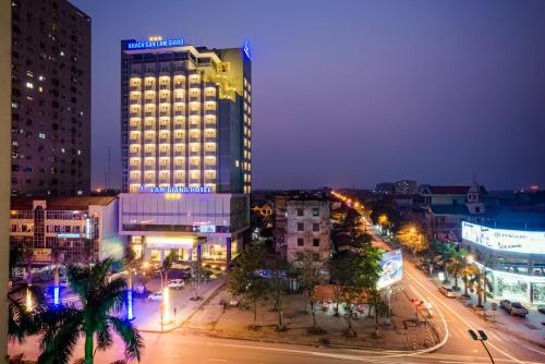 a night view of a city with a tall building at Lam Giang Hotel in Vinh