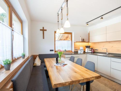 a kitchen and dining room with a wooden table and chairs at Chalet in Zell am Ziller near Ski Lift in Gerlosberg