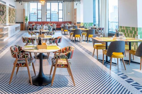 a restaurant with tables and chairs in a cafeteria at Hyatt House Nairobi Westlands in Nairobi