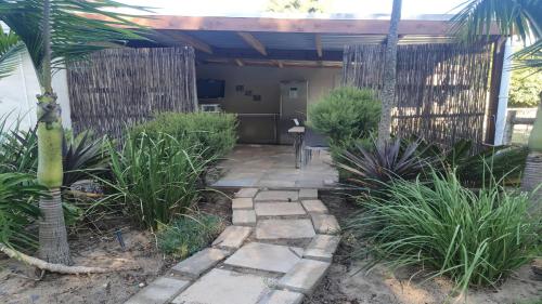 a garden with a patio with a table and a fence at New Hunters Moon in Joostenberg Vlakte