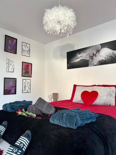 - une chambre dotée d'un lit rouge avec un cœur rouge dans l'établissement Love room proche du bassin , jacuzzi, jardin privé, à Marcheprime