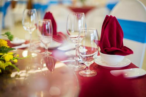 a table with wine glasses and napkins on it at Lam Giang Hotel in Vinh