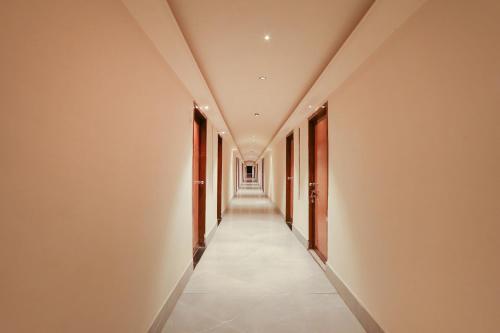 a corridor of a building with a long hallway at FabHotel Maruthi Residency - Nr Lakdikapul Metro Station in Hyderabad