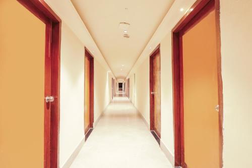 an empty corridor of a building with doors and a hallway at FabHotel Maruthi Residency - Nr Lakdikapul Metro Station in Hyderabad
