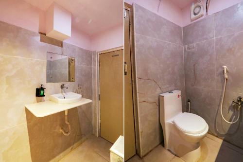 a bathroom with a toilet and a sink and a shower at FabHotel Maruthi Residency - Nr Lakdikapul Metro Station in Hyderabad