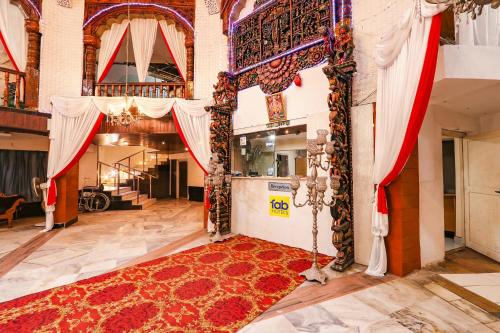 a large room with a red rug on the floor at FabHotel Maruthi Residency - Nr Lakdikapul Metro Station in Hyderabad