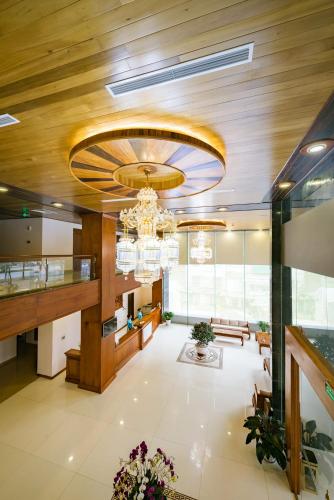 a lobby with a chandelier and a large room at Lam Giang Hotel in Vinh