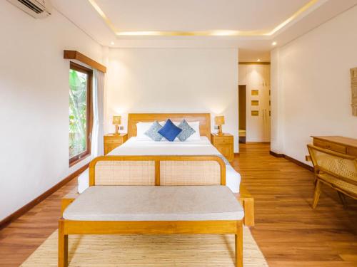 a bedroom with a bed and a piano at Ubud Shanti Rice Field House By Supala in Ubud