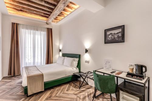 a hotel room with a bed and a desk at Effe Luxury Rooms in Rome
