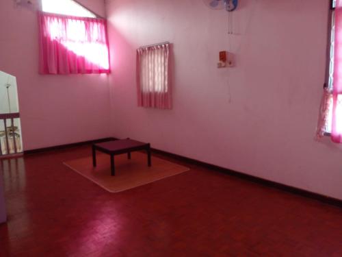a room with a table in the middle of a room at Villa Beach Anyer 2 in Kareo