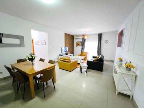 a living room with a table and a dining room at Apartment D - 3 Bedrooms in Cope