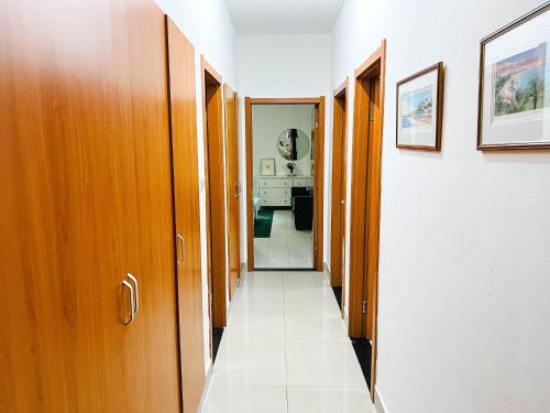 a hallway with wooden doors and a tile floor at Apartment D - 3 Bedrooms in Cope