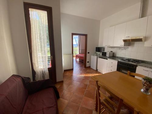 a kitchen and living room with a couch and a table at Casale del Vacanziere in Certaldo