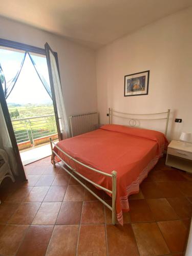 a bedroom with a bed and a large window at Casale del Vacanziere in Certaldo