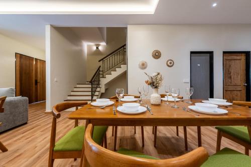 a dining room with a wooden table and chairs at La Ferringhi Villa - Balinese Collection, by ALV in Batu Ferringhi