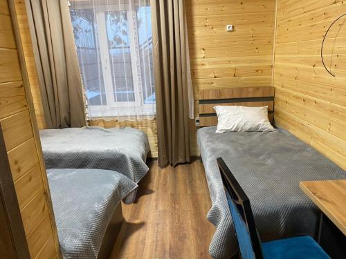 a room with two beds and a table and chairs at Syi-Ordo in Pokrovka