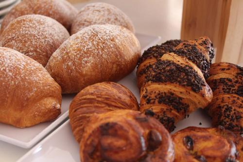 a table topped with lots of different types of pastries at Hotel Apis in Rimini
