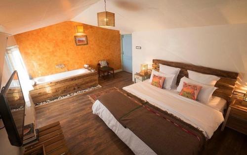 a bedroom with a large bed in a room at MeenaBagh Villa Rooms & Cafe in Shimla