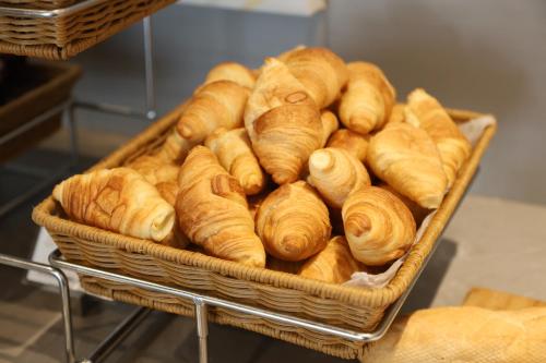 a basket full of croissants on a shelf at MiniMax Premier Hotel Shanghai Hongqiao in Shanghai