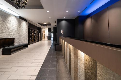 a hotel lobby with a bar with blue lights at Hotel Vista Sapporo Odori in Sapporo