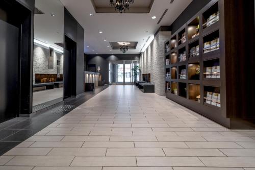 a hallway of a building with a tile floor at Hotel Vista Sapporo Odori in Sapporo