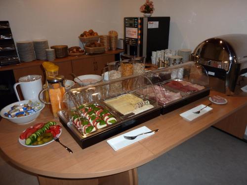 a table with a bunch of food on it at Garni Hotel Alber in Marktl