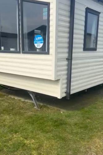 an exterior view of a mobile home with a window at Karen's Caravan in Great Yarmouth
