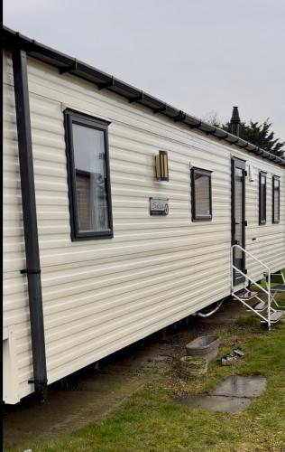 a white trailer with windows on the side of it at Karen's Caravan in Great Yarmouth
