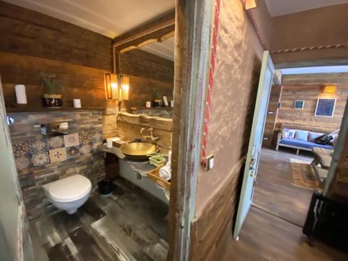 a bathroom with a toilet and a sink at MeenaBagh Villa Rooms & Cafe in Shimla