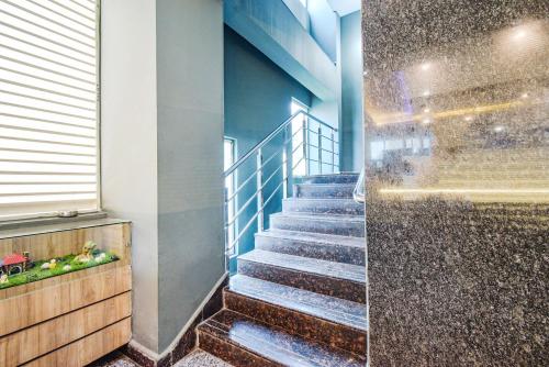 a set of stairs in a building with a shower at FabHotel Broholic Prime Suites - Nr Nexus Mall, Kukatpally in Kondapur