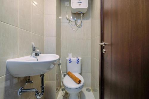 a bathroom with a sink and a toilet at Best Deal and Comfort Studio Citra Living Apartment By Travelio in Jakarta