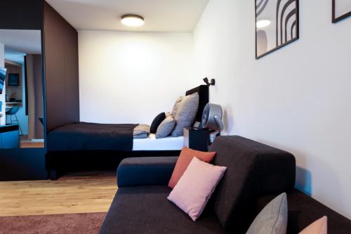a living room with a couch and a bed at KOCAK - Exklusives Apartment im Zentrum in Reutlingen