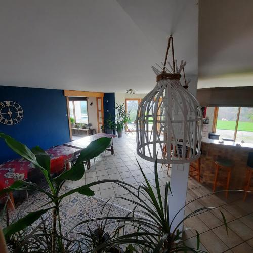 a room with a bird cage hanging from the ceiling at Magnifique villa avec piscine intérieure in Saint-Pois