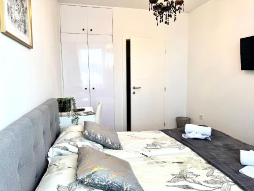 a bedroom with a large bed with pillows on it at COZY PLACE NEAR BUS AND RAILWAY STATION with common kitchen, bathroom and toilet in Zagreb