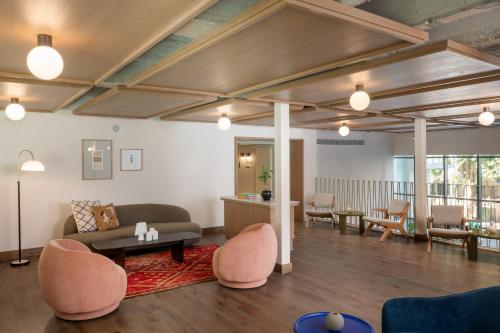 a living room with a couch and a table and chairs at master Mazeh in Tel Aviv