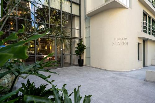 a courtyard outside a building with a potted plant at master Mazeh in Tel Aviv