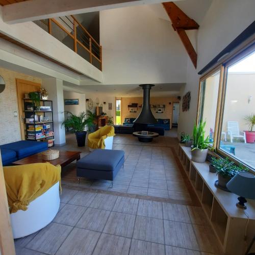 a living room with a couch and a fireplace at Magnifique villa avec piscine intérieure in Saint-Pois