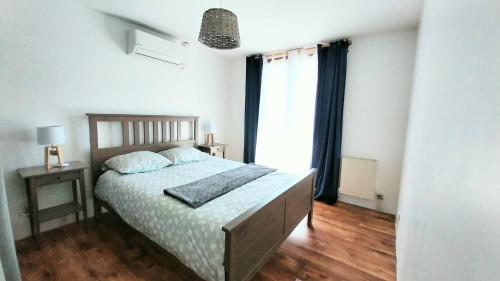 a bedroom with a bed and a large window at Maison avec piscine entre Chartreuse et Vercors in La Buisse