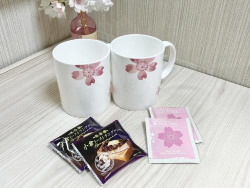 a table with two coffee cups and some books at Hotel Wing International Nagoya in Nagoya