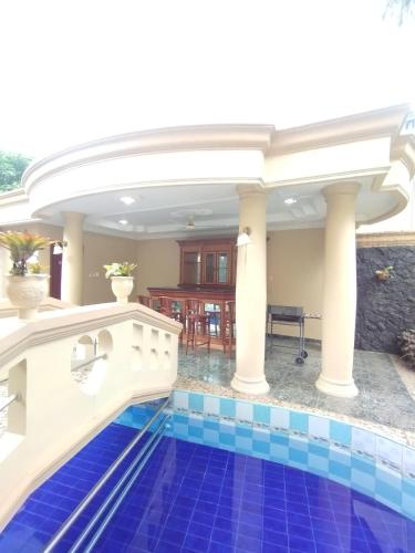 a swimming pool in a villa with a house at Vila Princess Sentul Privatepool 6 bedroom,5bathroom, Tenis meja, billiard in Gadok 1