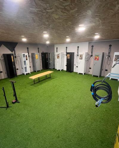 a room filled with lots of lockers and a ping pong table at L'Argalyde Esprit Pyrénées Wellness & Cycling in Ayzac-Ost