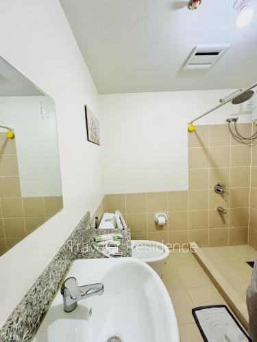 a bathroom with a sink and a toilet at Traveler Residence by Celandine in Manila