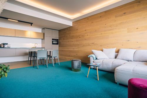 a living room with a couch and a kitchen at LAKESIDE Apartements in Zwenkau