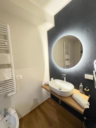 a bathroom with a sink and a mirror at 8380 La Cantina di Piero&Netta in Montemerano