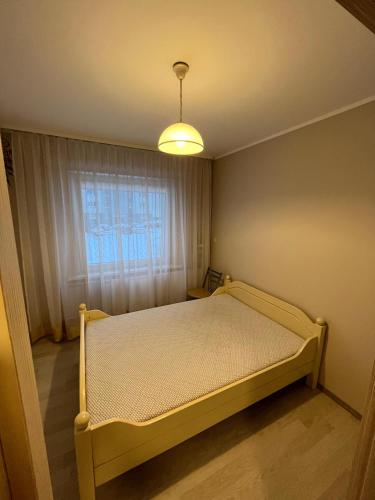Postel nebo postele na pokoji v ubytování Apartamentai Jonavoje #1