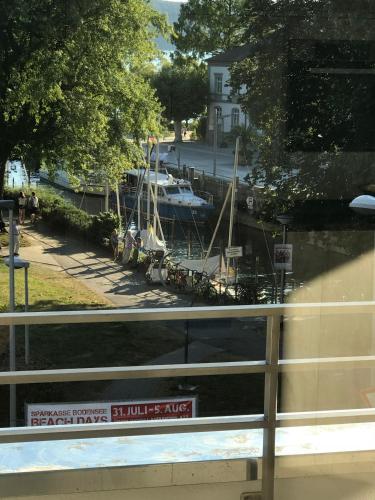 a boat docked in a marina with a sign on a window at Ferienwohnungen am Mantelhafen Typ 1 in Überlingen